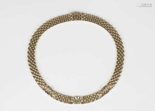 A 9ct two colour gold collar necklace in a multiple row oval...