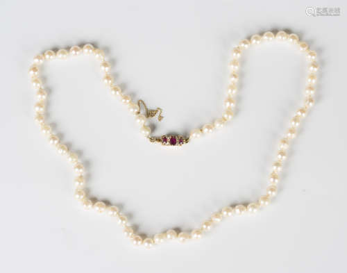 A single row necklace of baroque cultured pearls on a gold, ...