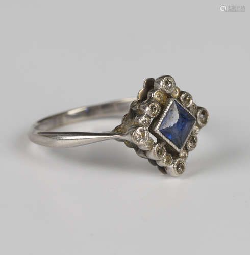 A diamond and sapphire square shaped cluster ring, mounted w...