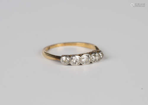 A gold and diamond five stone ring, collet set with a row of...