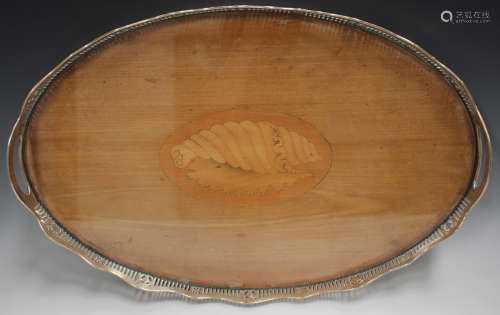 An Edwardian silver mounted mahogany oval gallery tray, the ...