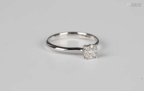 An 18ct white gold and diamond cluster ring, mounted with th...
