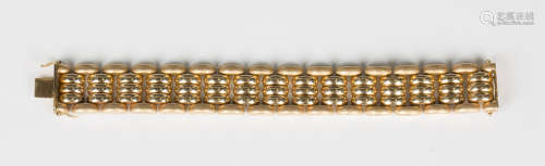 A gold wide oval link bracelet, the outer links with a brush...