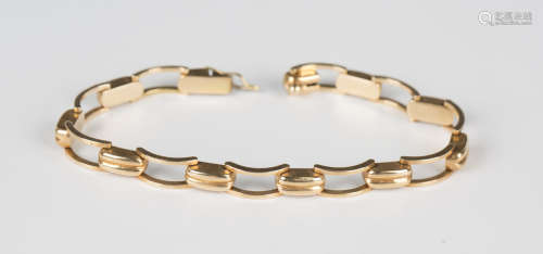 A gold bracelet in a curved and twin bar link design, on a s...