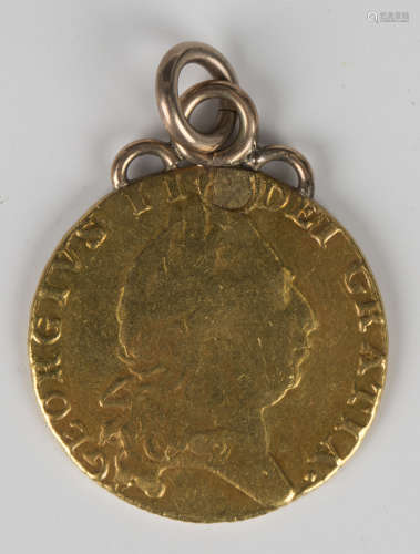 A George III spade guinea 1794, mounted as a pendant.Buyer’s...
