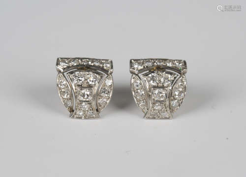 A pair of diamond earstuds, each in a curved panel shaped de...