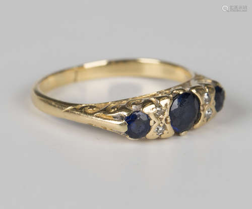 A gold, sapphire and diamond ring, mounted with three cushio...