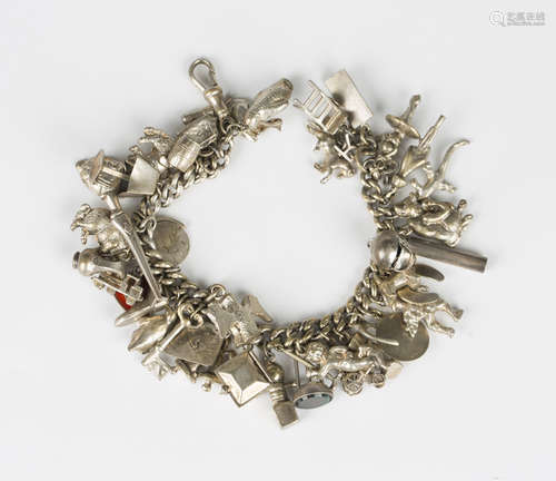 A silver curblink charm bracelet, fitted with a variety of m...