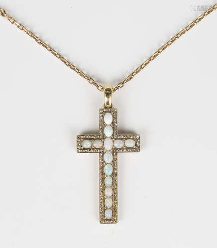 A gold, opal and diamond pendant cross, mounted with a row o...