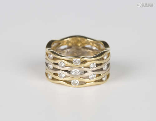A two colour gold and diamond wide band ring in a pierced ab...