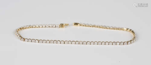A 9ct gold and diamond bracelet, designed as a row of circul...