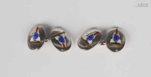 A pair of silver and enamelled oval cufflinks, decorated wit...