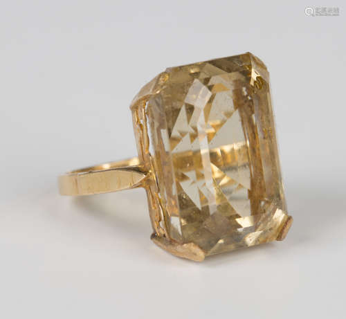 A gold ring, claw set with a cut cornered rectangular step c...