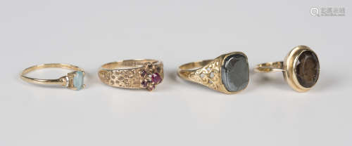 A 9ct gold ring, collet set with an oval cut smoky quartz, w...