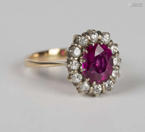 A gold, magenta sapphire and diamond oval cluster ring, claw...