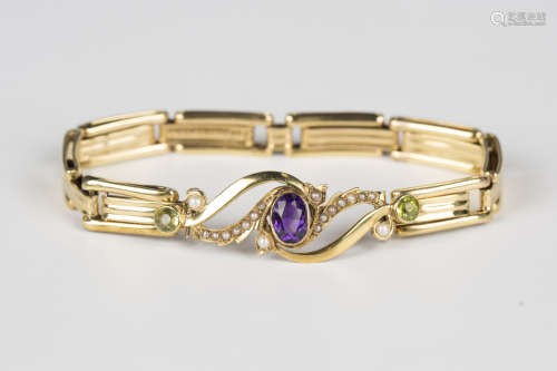 A gold, amethyst, peridot and seed pearl bracelet, the front...
