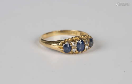 An 18ct gold, sapphire and diamond ring, mounted with three ...