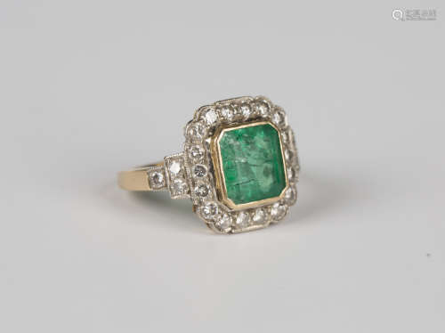 A gold, emerald and diamond cluster ring, mounted with the c...