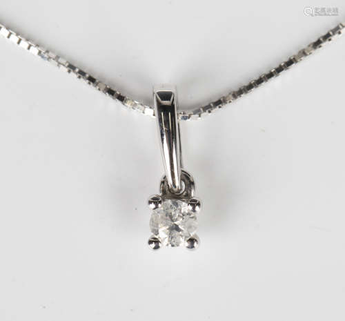 A white gold and diamond single stone pendant, claw set with...
