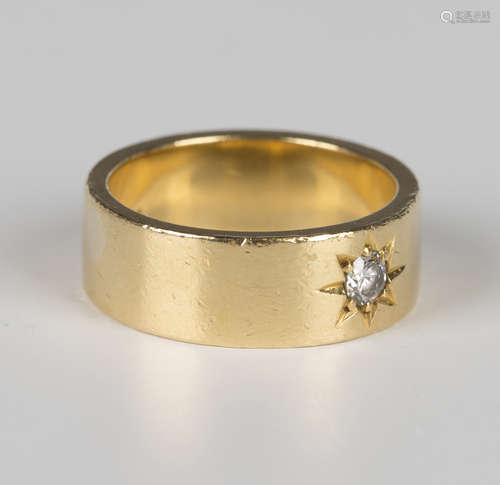 An 18ct gold band ring, star gypsy set with a circular cut d...