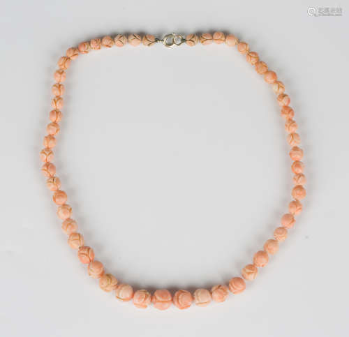 A single row necklace of graduated coral beads, each bead ca...