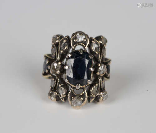 A sapphire and diamond ring in a pierced curved rectangular ...