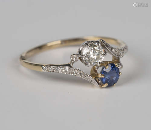 A gold, sapphire and diamond ring in a crossover design, cla...
