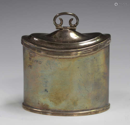 A George V silver oval tea caddy with reeded rims, the hinge...