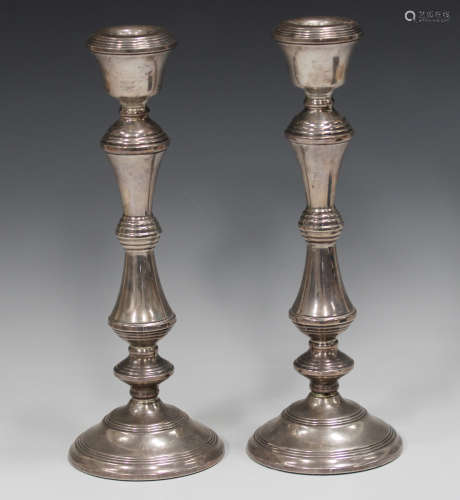 A pair of Elizabeth II silver candlesticks with turned stems...