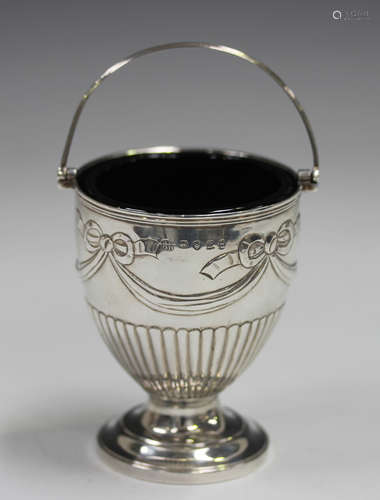 A George III silver basket with reeded swing handle, the hal...