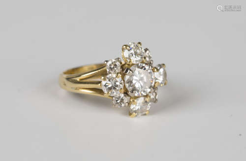 An 18ct gold and diamond nine stone cluster ring, claw set w...