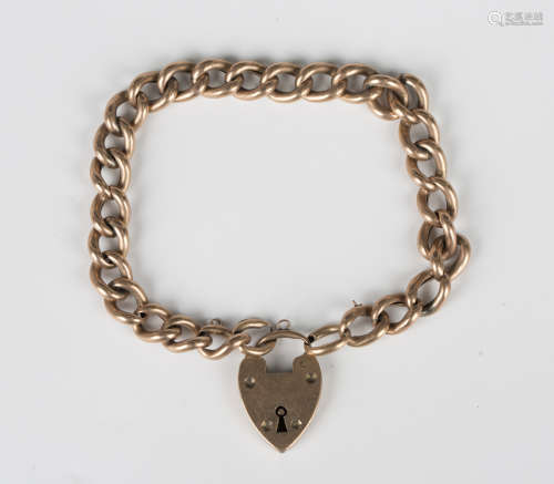 A gold hollow curblink bracelet with a gold heart shaped pad...