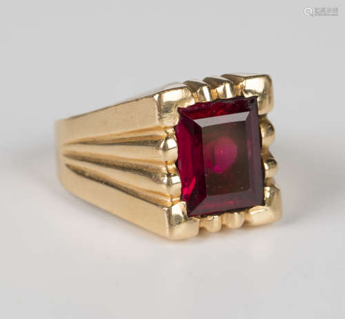 A gold ring, circa 1950, mounted with a rectangular step cut...