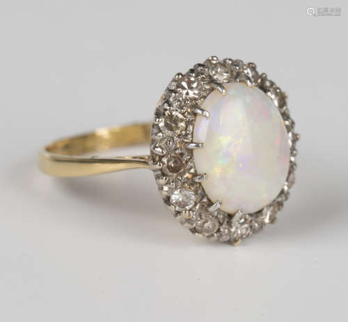 A gold, opal and diamond oval cluster ring, claw set with th...