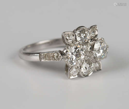A diamond ring of shaped rectangular panel form, claw set wi...