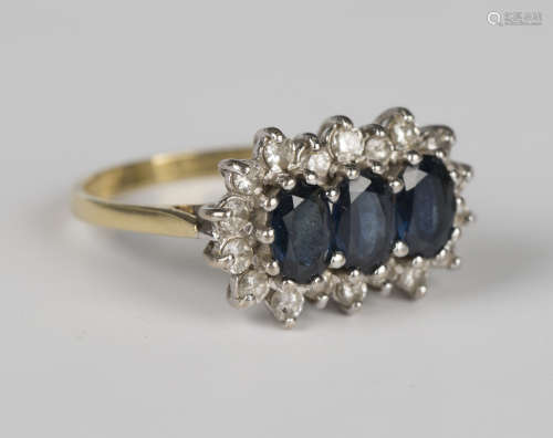 An 18ct gold ring, claw set with three oval cut sapphires wi...