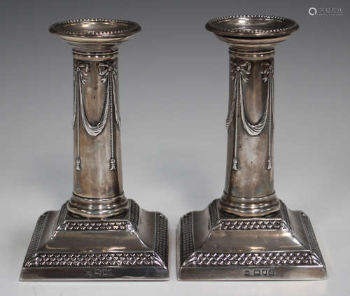 A pair of late Victorian silver candlesticks, each detachabl...