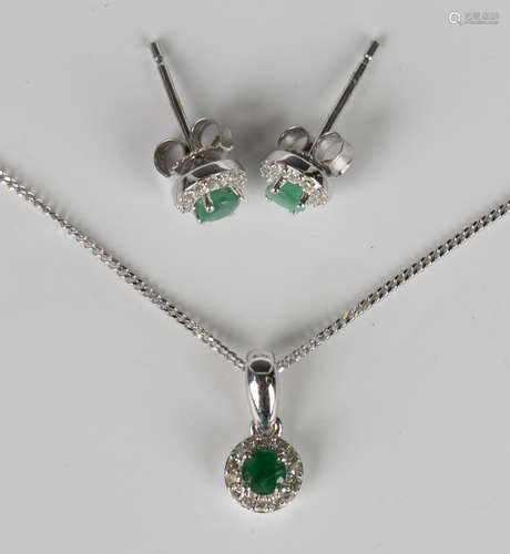 A white gold, emerald and diamond cluster pendant, detailed ...