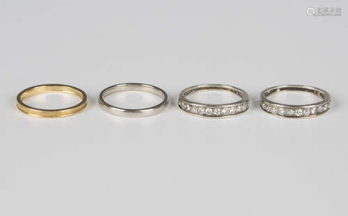 Two diamond half-hoop eternity rings, each mounted with a ro...