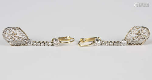 A pair of diamond pendant earrings, each drop of pierced ope...
