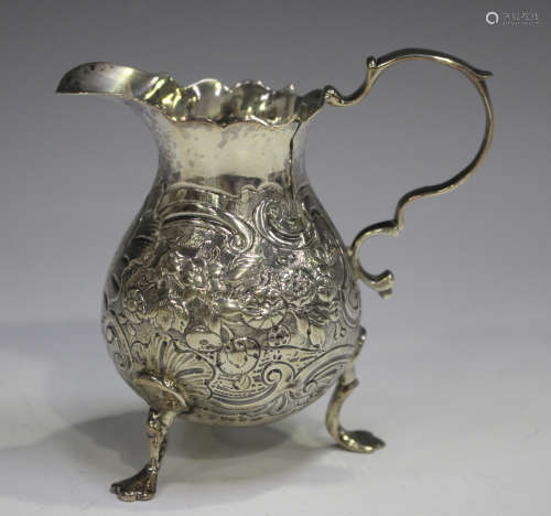A George II silver cream jug, the baluster body chased with ...