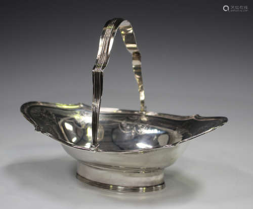 A George III silver basket with reeded swing handle and shap...