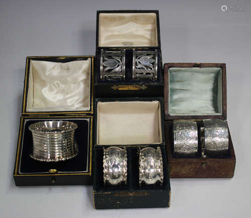 A pair of Edwardian silver napkin rings, pierced and engrave...