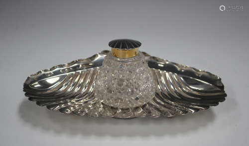 A late Victorian silver inkstand of scalloped form, fitted w...