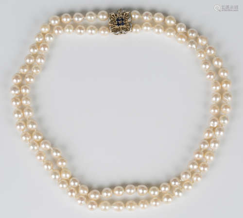 A two row necklace of uniform cultured pearls on a 9ct gold,...