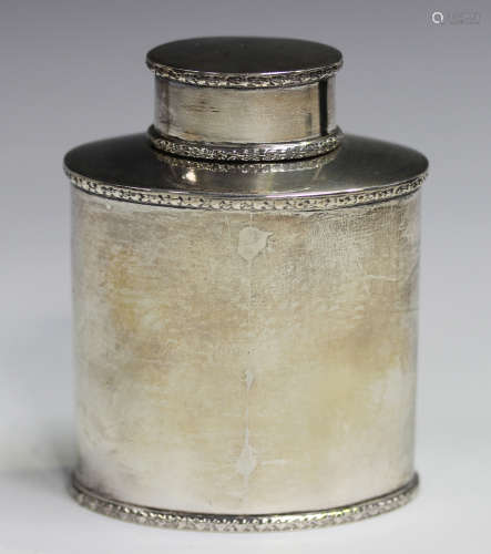 A George V silver oval tea caddy and cover, decorated in rel...