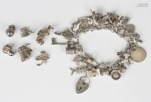 A silver charm bracelet, fitted with a variety of mostly sil...