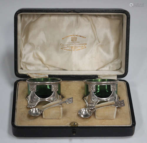 A pair of Art Nouveau silver oval salts and matching spoons,...