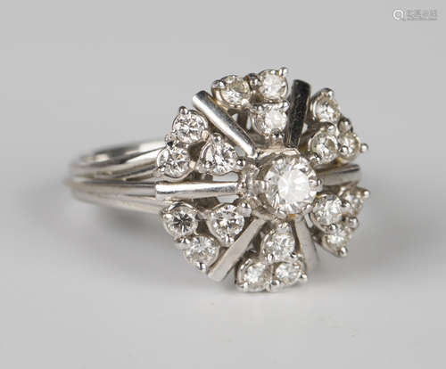 A white gold and diamond cluster ring, claw set with the pri...