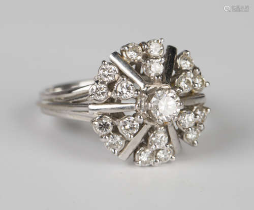 A white gold and diamond cluster ring, claw set with the pri...